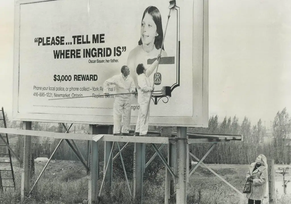 Ingrid Bauer: photo of workers erecting a billboard with her picture and case info