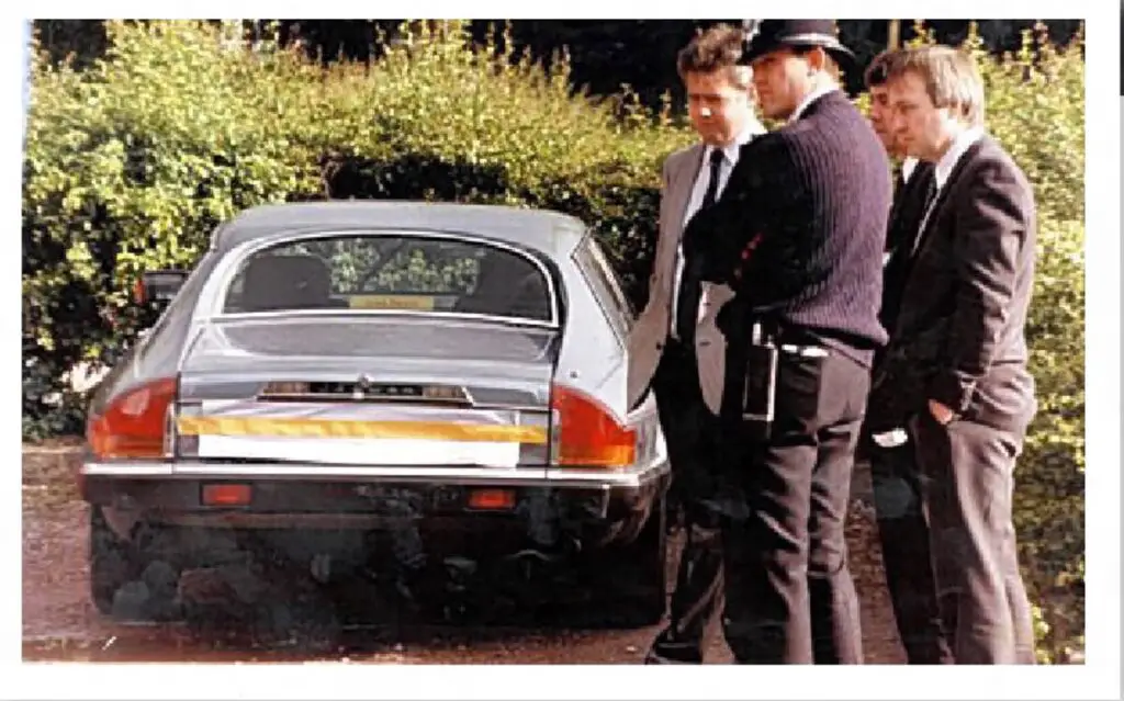 Penny Bell: newspaper photo of police standing outside her car at the crime scene